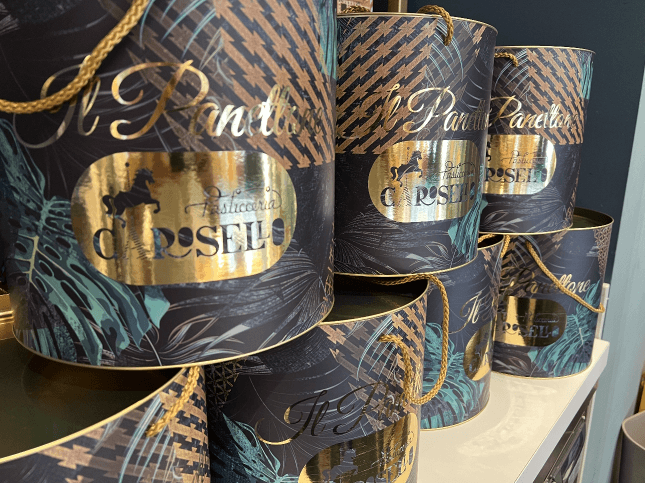 Confezioni di panettone della Pasticceria Carosello con decorazioni dorate e motivi tropicali